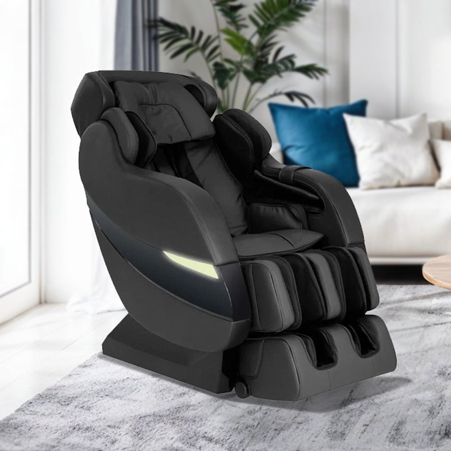 Kahuna Massage Chair SM-7300S in black, showcased in a modern living room with white sectional sofa, wood coffee table, and contemporary décor from Wish Rock Relaxation