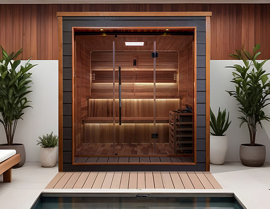 Golden Designs "Bergen" 6 Person Outdoor Traditional Sauna in Canadian red cedar placed poolside with modern decor from Wish Rock Relaxation