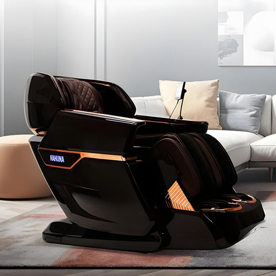 Kahuna EM-8500 Massage Chair in sleek black with gold accents, displayed in a modern living room with white sectional sofa, round wood coffee table, and contemporary décor from Wish Rock Relaxation