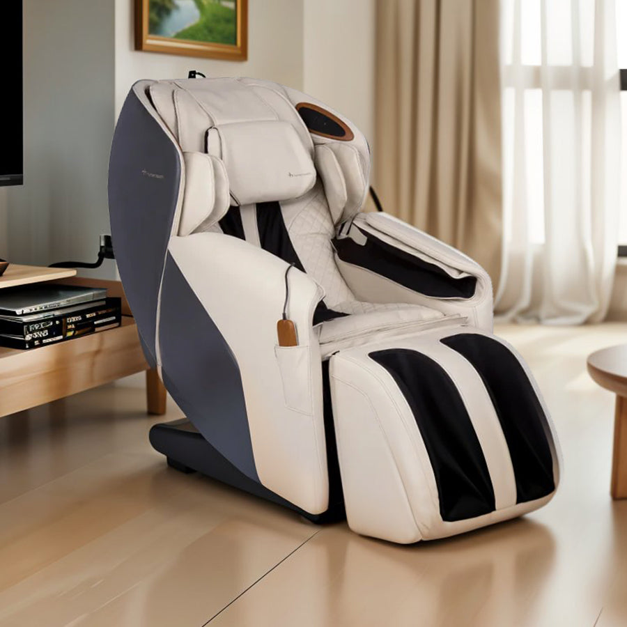 Human Touch Quies Massage Chair in cream placed in a modern living room beside a red sofa and coffee table from Wish Rock Relaxation.