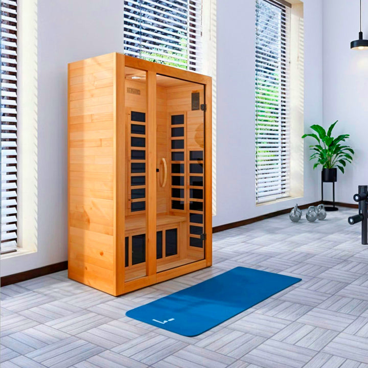 Gracia 1–2 Person Low EMF FAR Infrared Sauna in Canadian Hemlock shown in a bright home wellness space, featuring full-spectrum infrared heaters, tempered glass door, and compact wood design from Wish Rock Relaxation.
