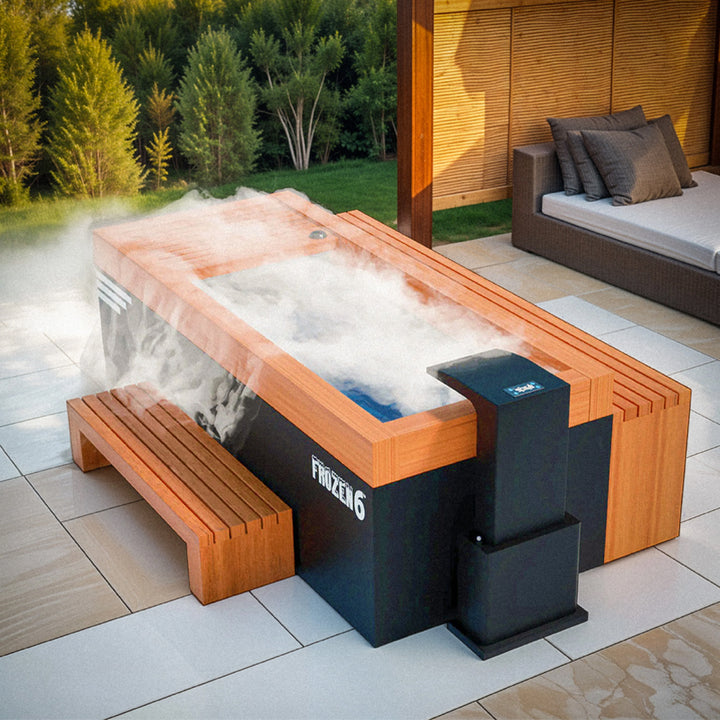 Medical Breakthrough Frozen 6 Cold Plunge with wood trim, cooling system, and matching bench releasing cold mist in modern outdoor patio from Wish Rock Relaxation