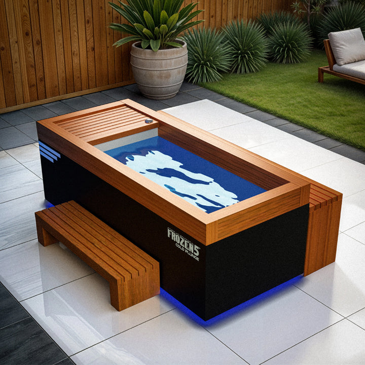 Medical Breakthrough Frozen 5 Cold Plunge with wood trim, matching bench, and blue LED base lighting in outdoor patio from Wish Rock Relaxation.